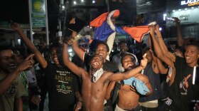 Fans celebrate Haiti's qualification for the 2026 FIFA World Cup after a soccer match against Nicaragua, in Port-au-Prince, Haiti, Tuesday, Nov. 18, 2025.