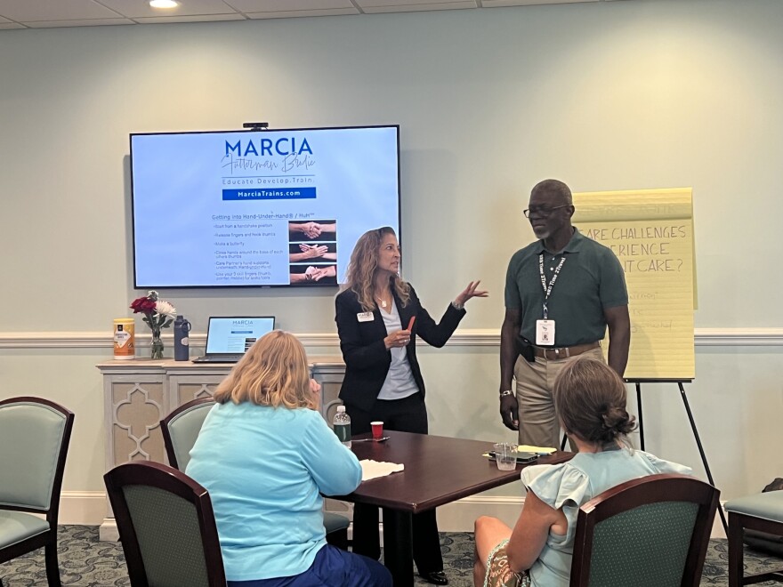 Marcia Brodie (left), a Norfolk-based dementia caregiver educator, leads a training on communication strategies for families and care staff working with people living with dementia.