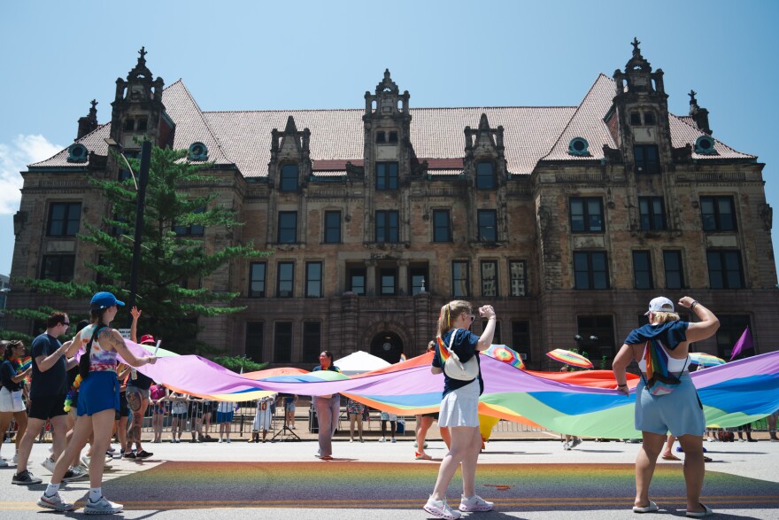 A vast rainbow flag is held in front of City Hall during the annual Pride parade in downtown St. Louis on Sunday, June 28, 2026.