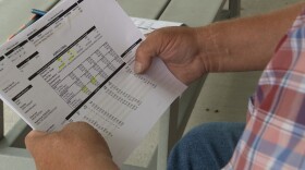 A man holds a sheet of paper