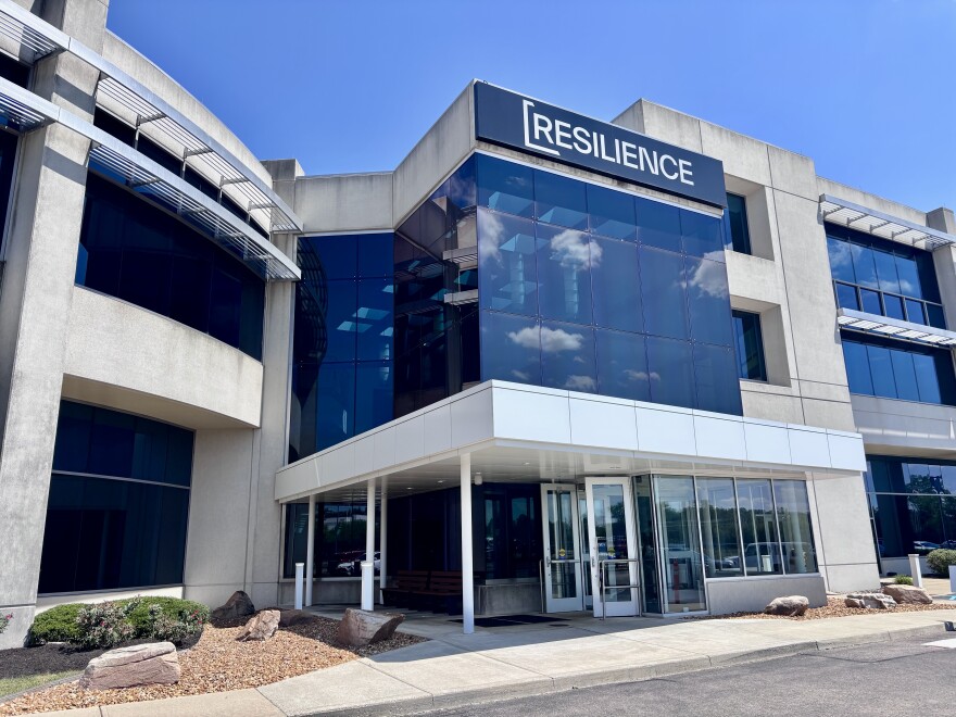 A large building concrete with lots of windows and a word displayed at the very top: Resilience