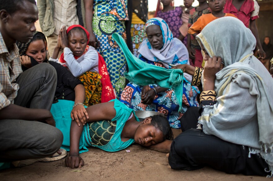 People comfort the sister of a Muslim man who was kidnapped, held for ransom and then murdered when his family could not pay the amount demanded by kidnappers in Paoua town. Kidnapping and extortion are part of the scene in lawless areas of the Central African Republic.