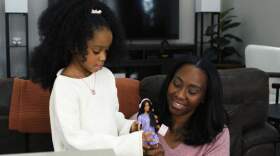Precious and Mikko Mirage play with Barbie. (Courtesy of Mattel)