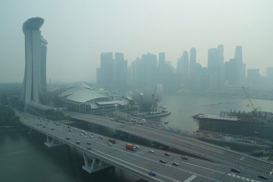 A thick haze obscures the skyline behind the Central Business District area in Singapore, Friday, Oct. 9, 2026. (AP Photo/David Hu)
