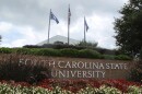 FILE - In this July 22, 2014, file photo, flags fly at the entrance to South Carolina State University in Orangeburg, S.C. A student faces charges after a shooting at South Carolina State University on Tuesday, Feb. 6, 2024 that sent the campus into lockdown for nearly one hour but did not leave any reported injuries. (AP Photo/Bruce Smith, File)