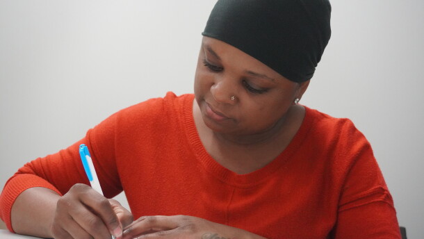 Elsie Alex-Tanner, crisis intervention specialist at Marion Senior Services, writing on her notepad. (Rachel Hunter/WUFT News)