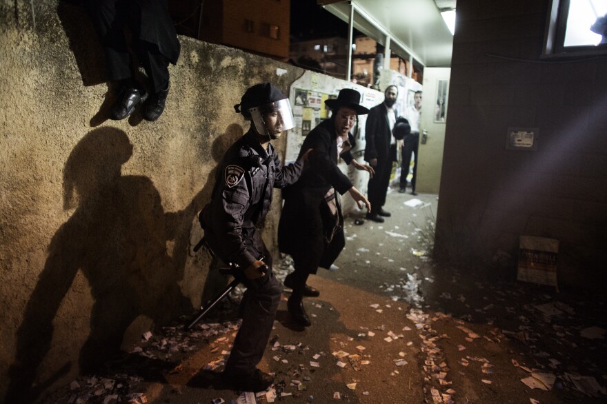 An Israeli police officer arrests an Ultra-Orthodox Jew during a protest against the draft law in Jerusalem on May 16.