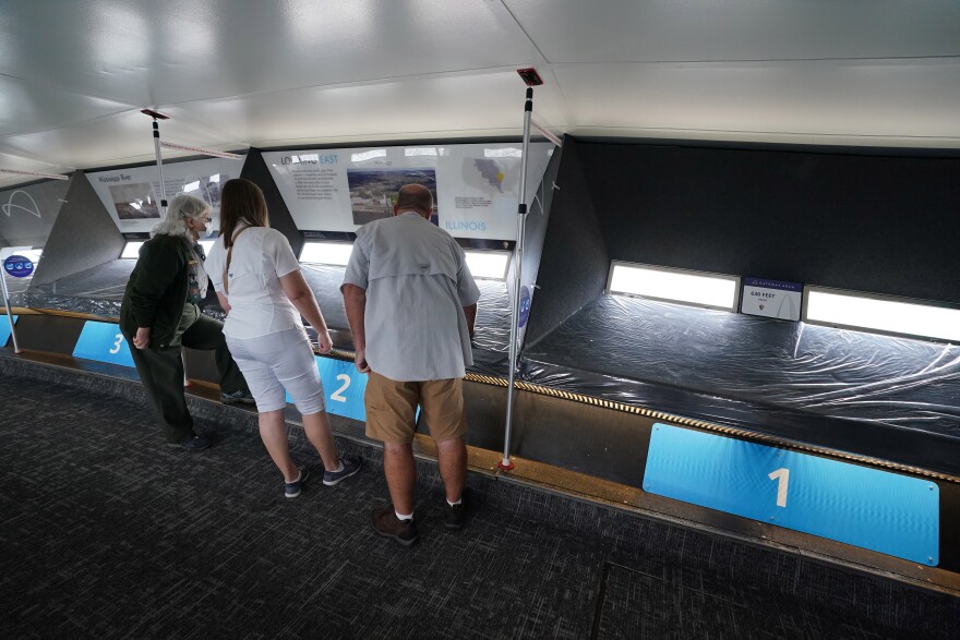 Visitors to the top of the Gateway Arch, look out of the window from their assigned spots in St. Louis on Wednesday, September 2, 2020. Trips to the top of the 630 foot monument have resumed, since closing in March due to the coronavirus. Visitors are assigned a time to enter and must stand in one area before leaving down the other leg of the Arch.