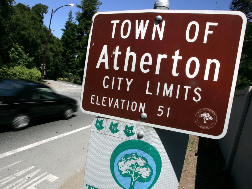 A car passes by the Town of Atherton city limits sign July 12, 2005, in Atherton, Calif.