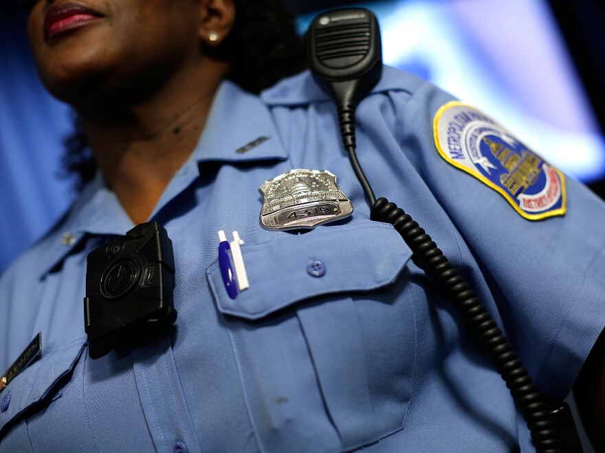 A Washington, D.C., Metropolitan Police officer wears a camera during a news conference in 2014.