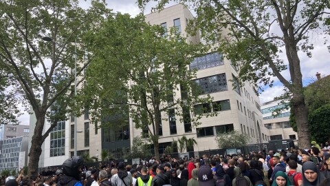 A crowd gathers in front of the Ibn Badis mosque where mourners gathered to pay respects Saturday in Nanterre, France.