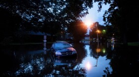 An abandoned car is seen in a flooded street on Aug. 15, 2016 in Baton Rouge, Louisiana. (Brendan Smialowski/AFP/Getty Images)