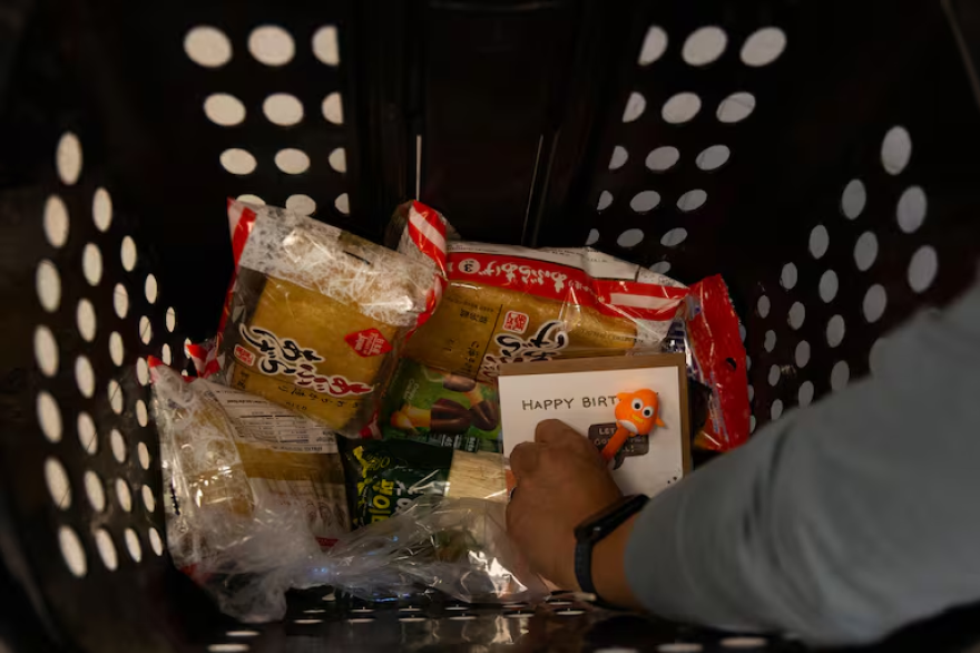 Looking down on a shopping basket with specialty goods and a greeting card.