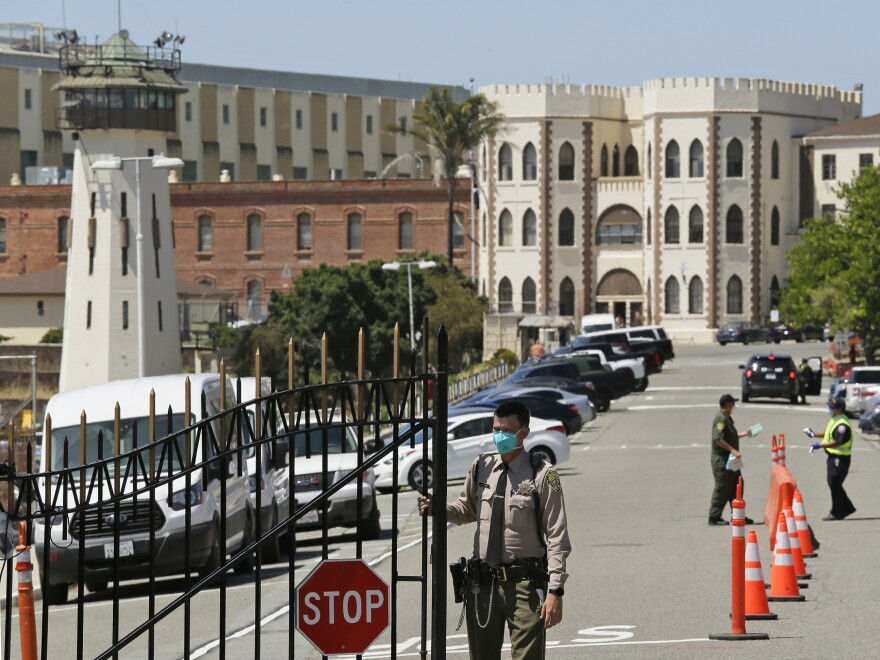 A correctional officer closes the main gate at San Quentin State Prison in San Quentin, Calif., in 2020. In September 2020, California Gov. Gavin Newsom signed a bill that requires the state to house transgender prisoners based on their gender identity. The law became effective in 2021, and the state has started slowly moving inmates who have requested a change and gone through steps for approval.