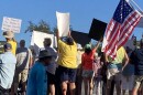 Protestors wave signs at the No Kings demonstration in Charlotte County on October 18. They're worried about President Trump's attempts to expand executive branch power. Other citizens say they're feeling freer than ever with Trump in the White House.