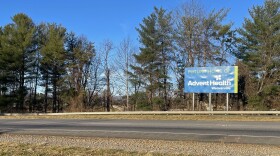 A western North Carolina hospital was supposed to be built and running by 2025, but the state's certificate of need law has been used to delay the project for years. A sign in the mountain region heralds the coming hospital, but the site behind it is just a field of dirt.