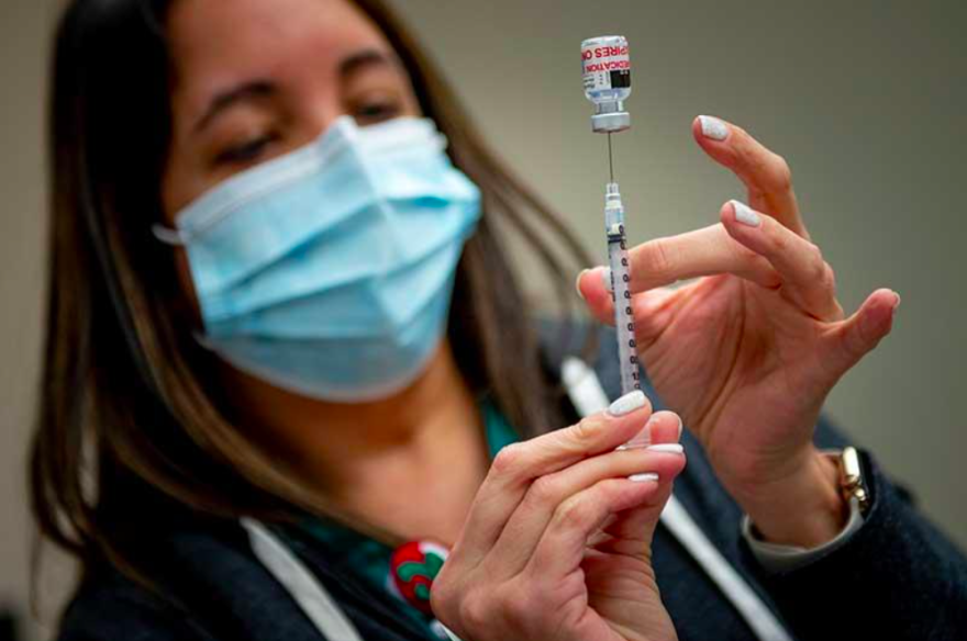 Jeannine Trabeaux draws up a dose of the vaccine. 