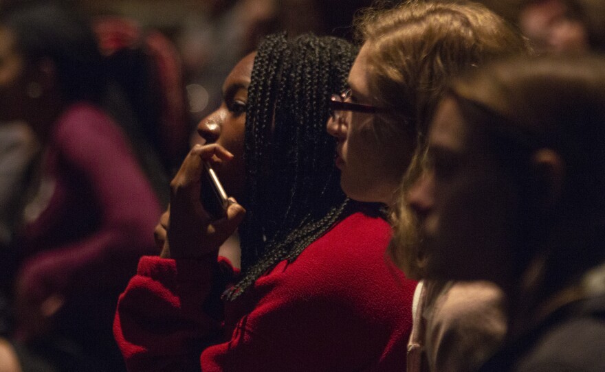 A group of girls sitting in the crowd.