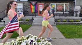 Runners pass the Retro Cafe on Capouse Ave during a training run with the Barrier Breakers.