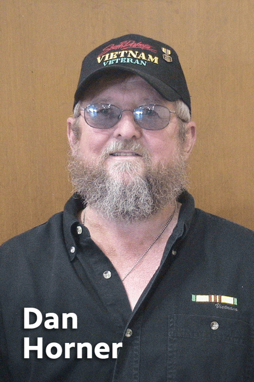 Dan F Horner wearing black shirt and black baseball cap