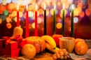 This stock photo shows Kwanzaa decorations, including seven candles in red, black and green.