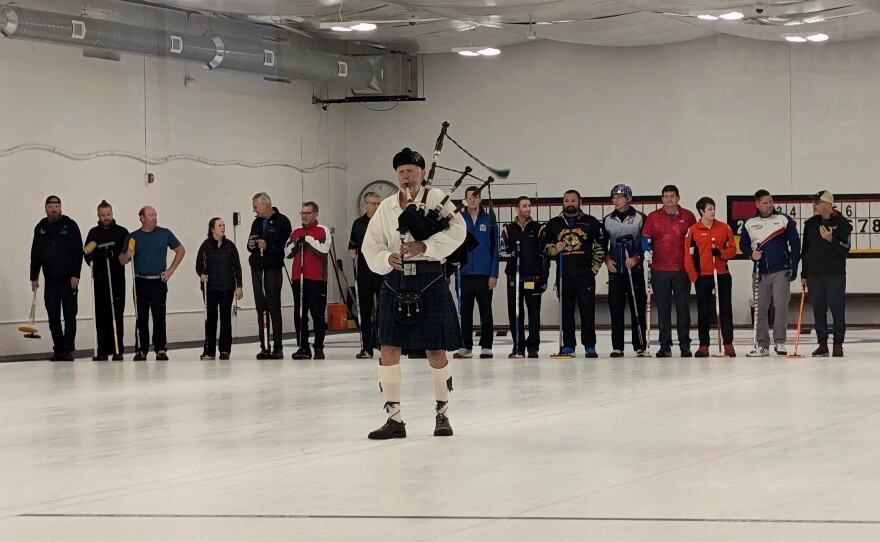A bagpiper leads curlers out onto the ice during the End of Summerspiel finale on September 22, 2024.
