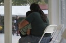 A woman hugs a child