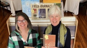 Photo of Sandy Carlson and Kaye McIntyre holding copies of Field Journal