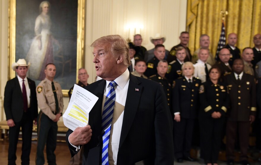 President Trump responds to a reporter's question during an event with sheriffs in the East Room of the White House on Wednesday.