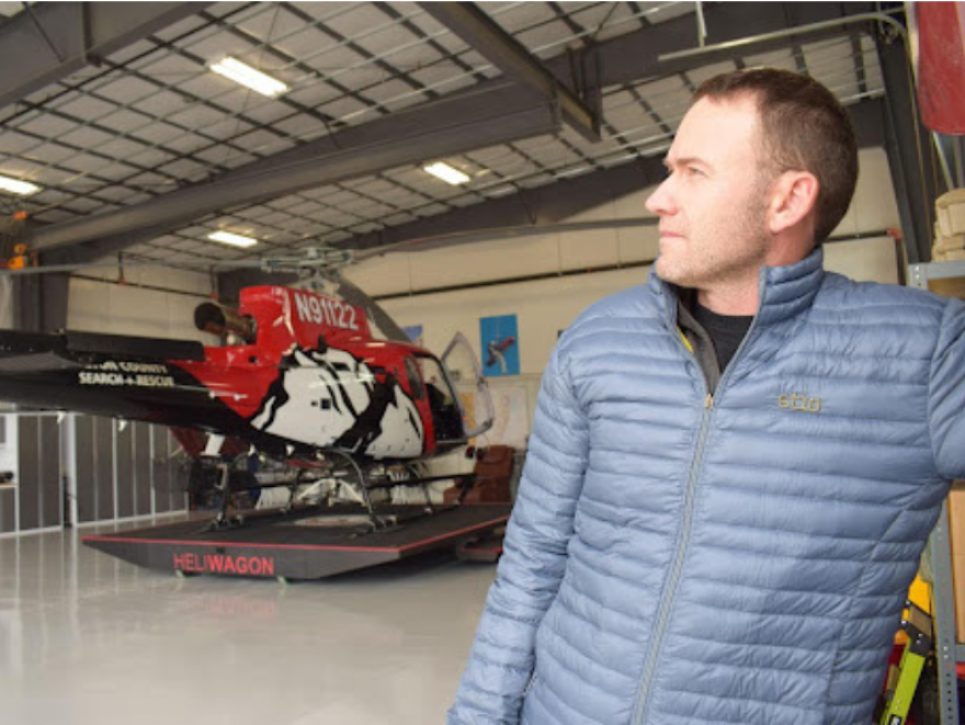 TCSAR helicopter pilot Steve Wilson opens the hangar door, preparing for training. Wilson flew the “ship” into Jackson in October 2023.