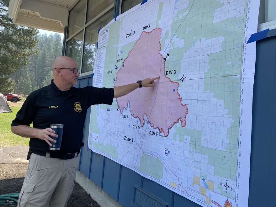 Brandon Fowler, emergency manager for Klamath County, points out the power lines that run through the heart of the Bootleg Fire area. Fowler is stationed with state incident commanders and other fire officials at their command station at Chiloquin High School.