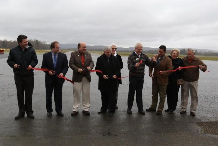 State and local officials cut a red ribbon at the Northeast Kingdom International Airport