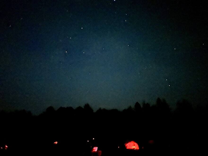 Red lamps, used to preserve night vision for observing, are seen on a field at the Cherry Springs Star Party in northern Pennsylvania.