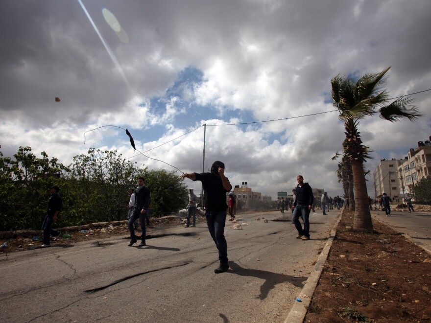 Palestinian youths hurl rocks at Israeli soldiers in Silwad on April 19, during clashes after a protest against the expropriation of Palestinian land by Israel. Last month, the Israeli prison authority said all of the Palestinian youths in prison for throwing rocks were boys.