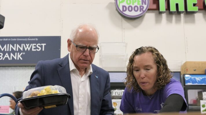 Gov. Tim Walz, left, helps volunteer Leah Raiche sort donations at The Open Door food shelf in Eagan on Oct. 27, 2025.
