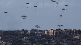 Parachutes drop supplies into the northern Gaza Strip. (Leo Correa/AP)