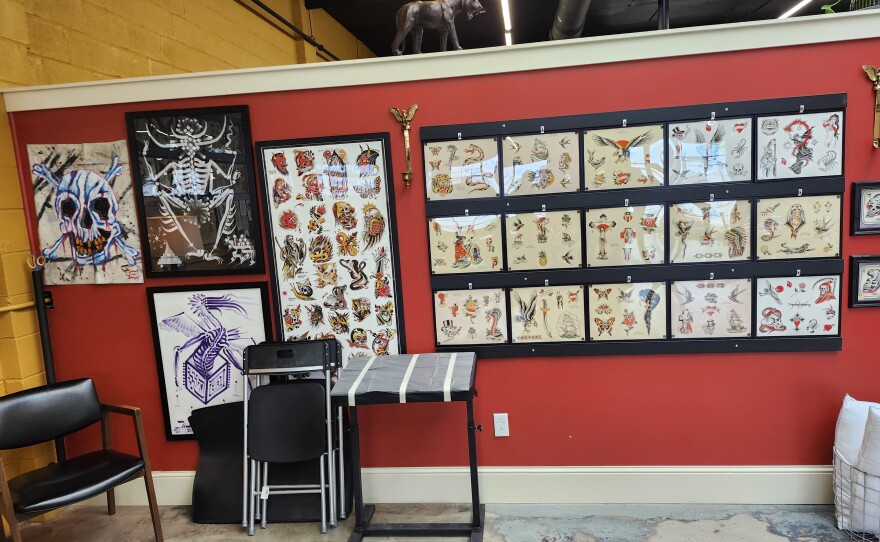 Images of tattoos hanging on a wall.