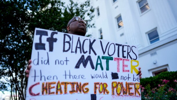 Travis Jackson, of Montgomery, holds a sign about Black voters outside the Alabama state house during a special session of the Alabama Legislature, Tuesday, May 5, 2026, in Montgomery, Alabama.