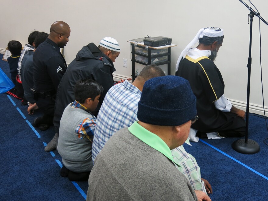 Alexander (at left), a practicing Muslim, prays during a visit to a Los Angeles-area madrassa, part of his unit's outreach to the Muslim community.