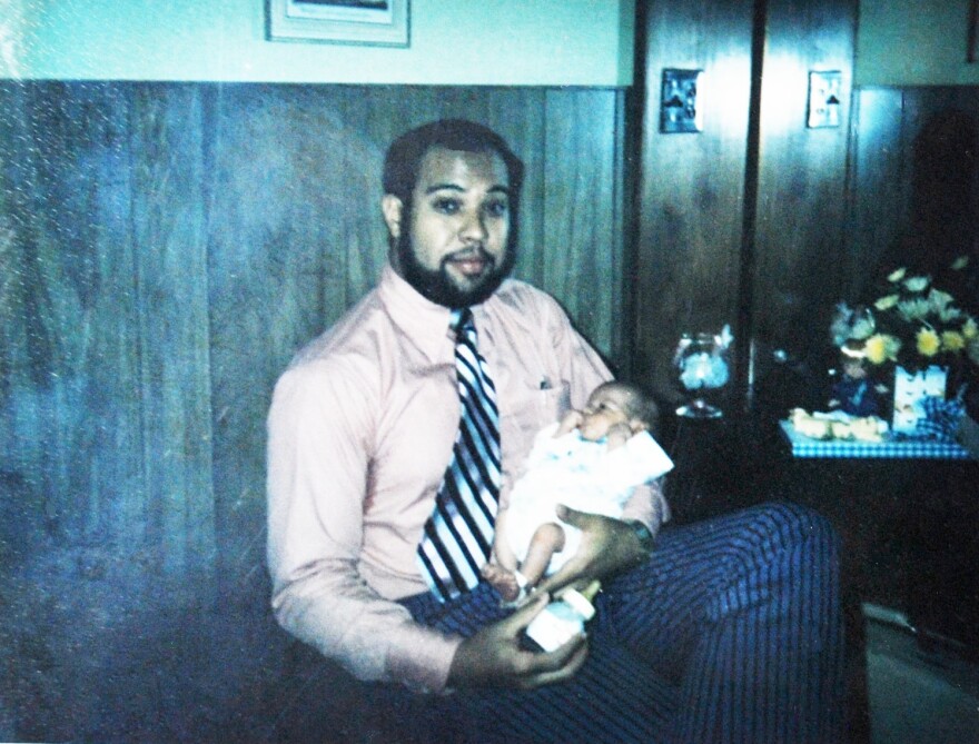 Dr. Moseley is holding his son, Jay.