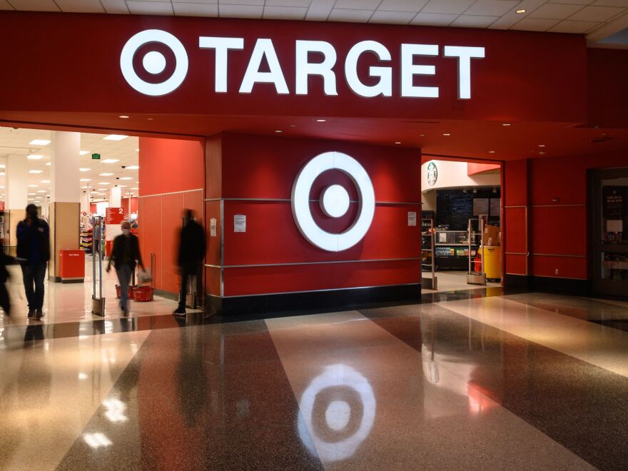 Shoppers enter a Target store in Washington, D.C., on Feb. 17. Target said earnings fell in the first three months of the year as rising costs are eating into profits, among other factors.