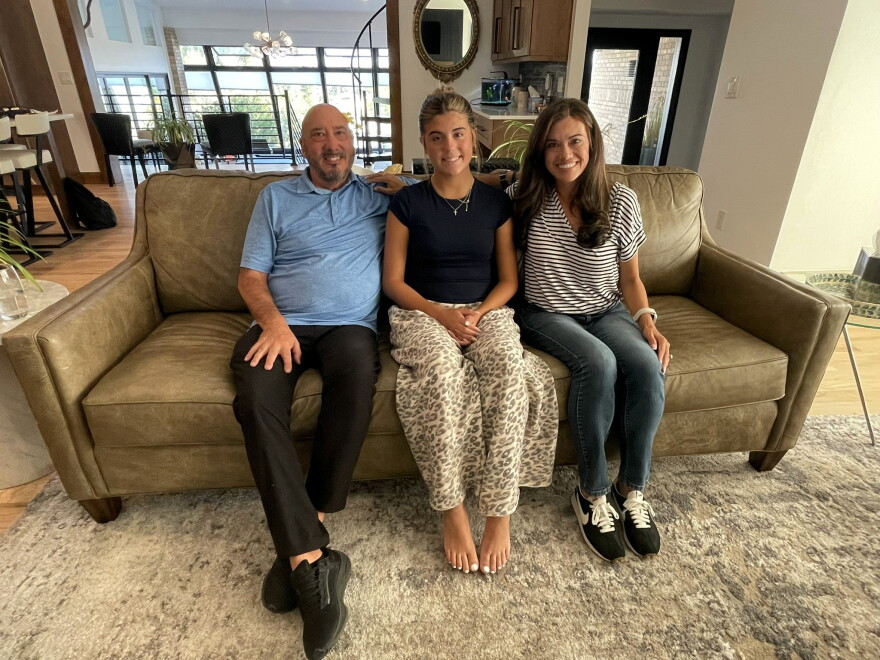 From left, Dennis Deslongchamp, Emily Peterson and Stella Deslongchamp sit at their home in Arvada on Sept. 22, 2026. Through Alyssa’s Light, the family works to educate parents, young athletes and coaches about concussions and mental health.