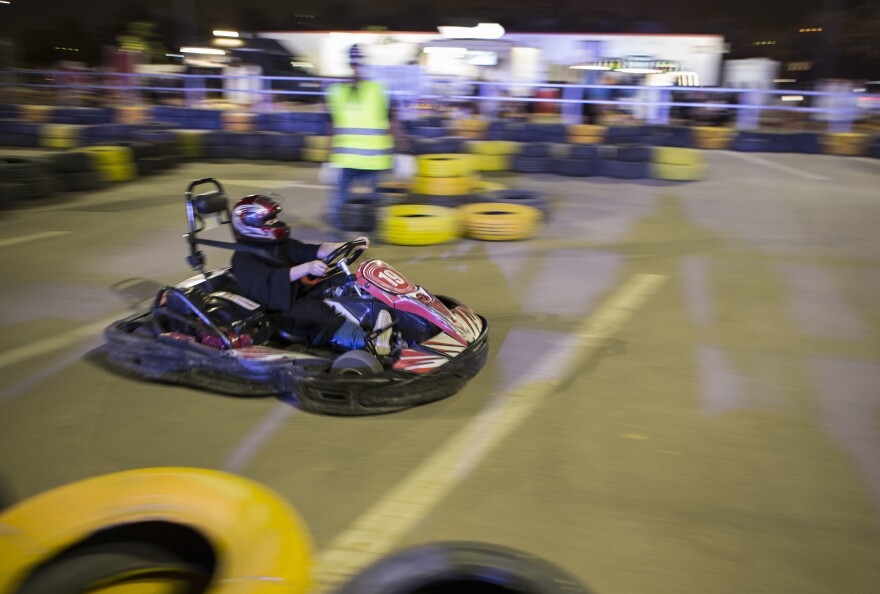 A day before the ban was lifted, a Saudi woman drives a go-kart at Riyadh Park Mall at an educational event to prepare Saudi women to take the wheel.