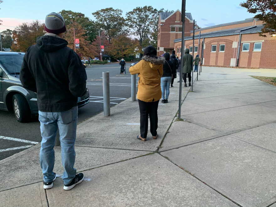 Voters line up at a polling place at Wilbur Cross High School in New Haven on Nov. 3, 2020.