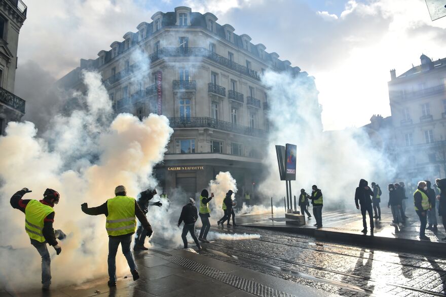 Protesters clash with police as tear gas is used during an antigovernment demonstration called by the yellow vests in Angers, in western France, on Jan. 19.