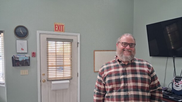 Jeff Newman, executive director of Our Own Lives, stands inside the nonprofit's office in Cortez. Newman says the organization is working to build disability services around the strengths, goals and lived experiences of the people it supports. (LP McKay/KSJD)