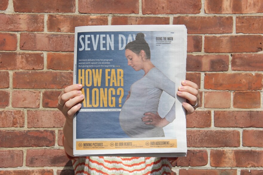 A woman holds a copy of the weekly newspaper Seven Days featuring a story in the "Hooked" series on opioids and addiction.