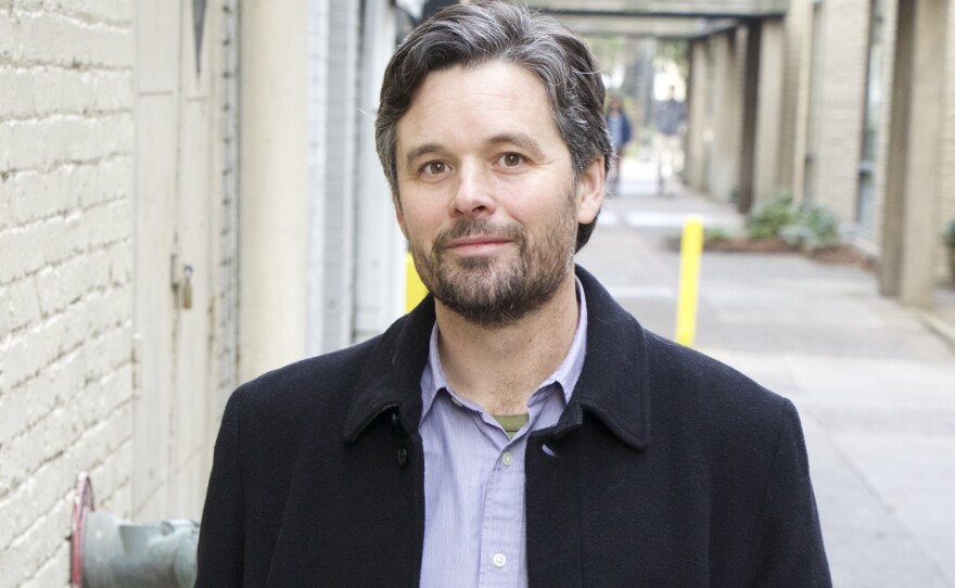 Man standing and looking into camera