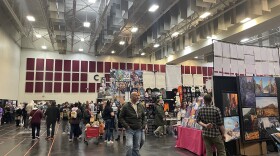 Attendees peruse vendor booths on the main convention floor.