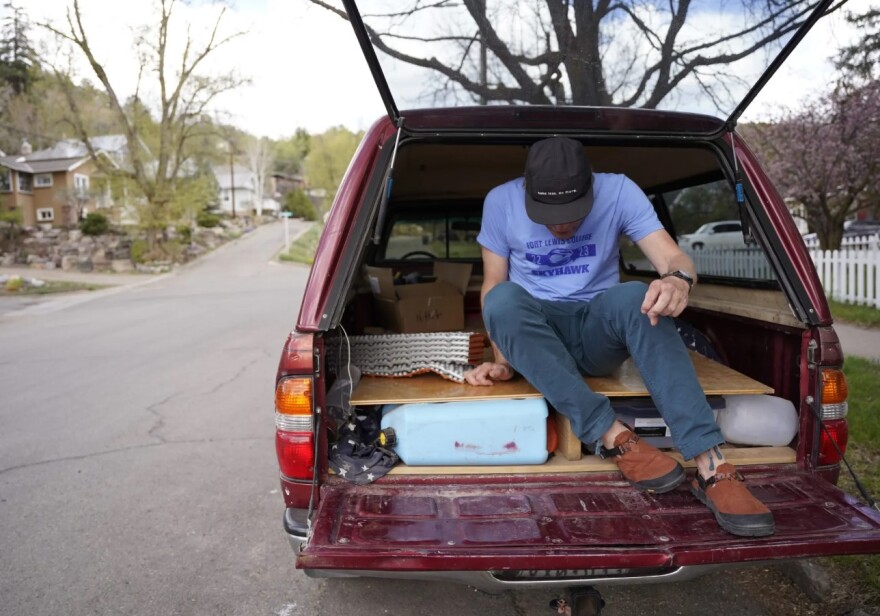 Jason Pettit climbs out of his Toyota Tacoma on May 3 in Durango. He previously lived in a Ford Ranger while attending Fort Lewis College as a nontraditional student. His Tacoma is similarly equipped for camping.